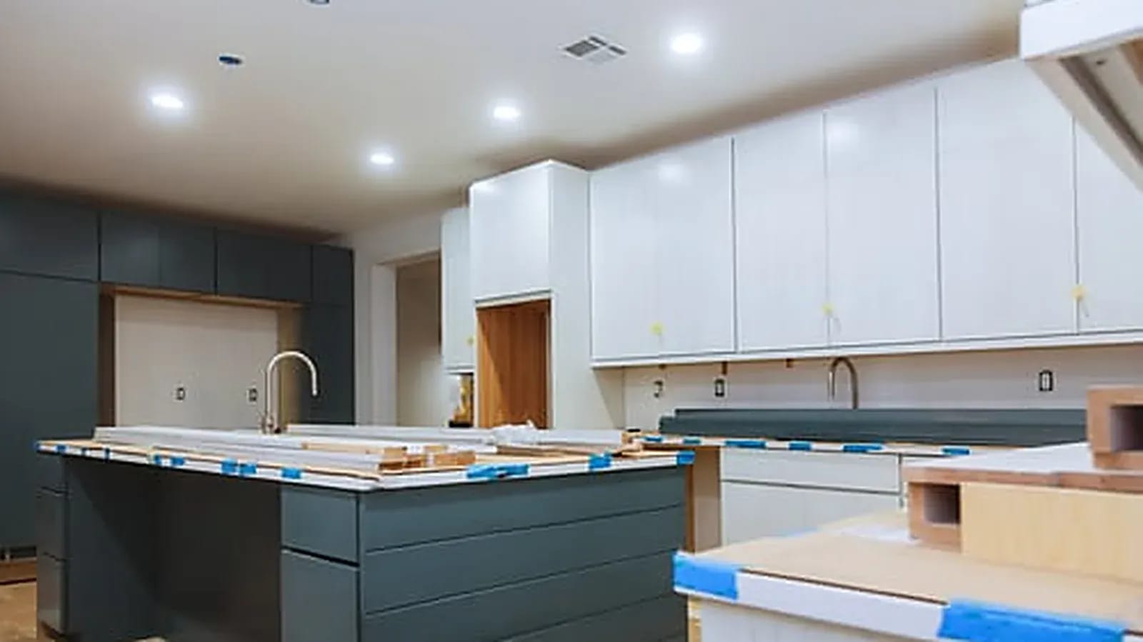 Interior remodeling project showing new cabinetry, island and finished drywall